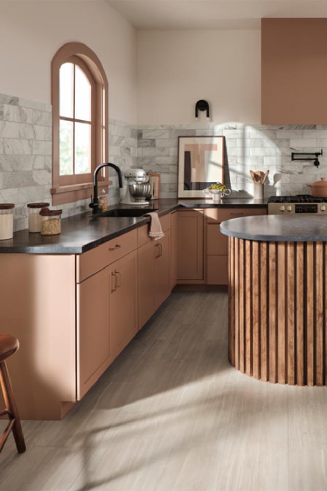 Tuscan Inspired Kitchen with wood look flooring and tile backsplash